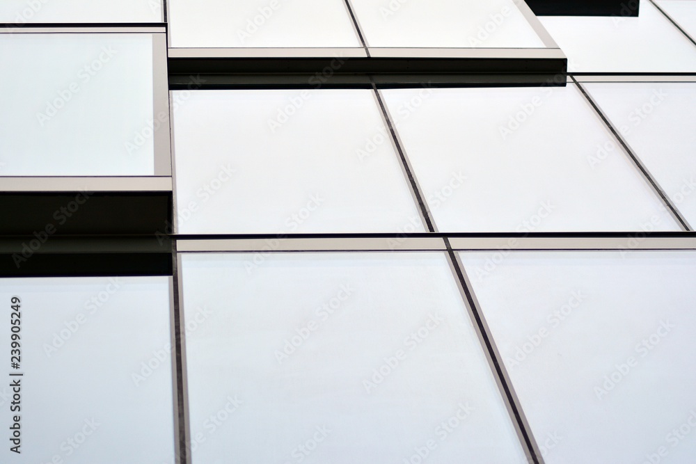 Facade fragment of a modern office building. Exterior of glass wall with abstract texture.