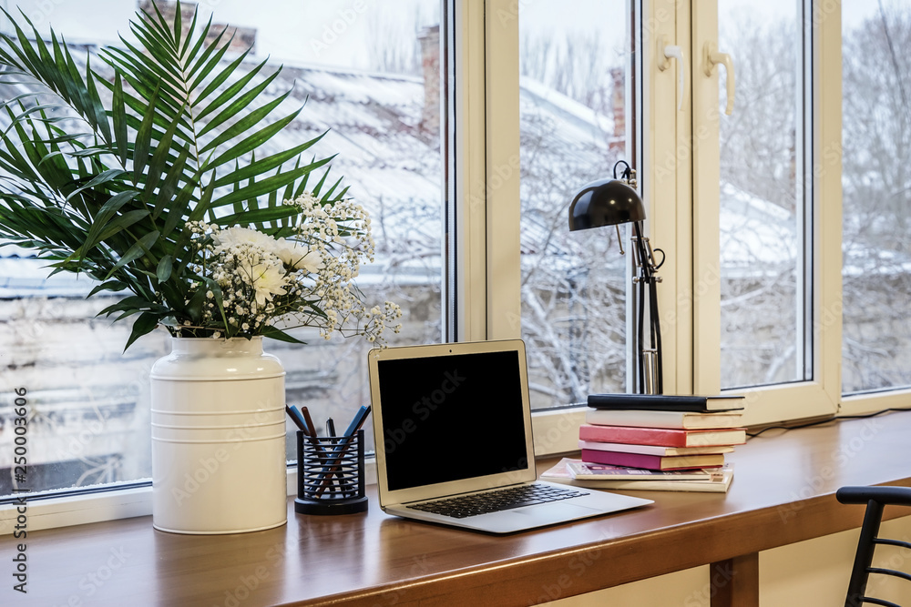 Interior of modern room with comfortable workplace near window