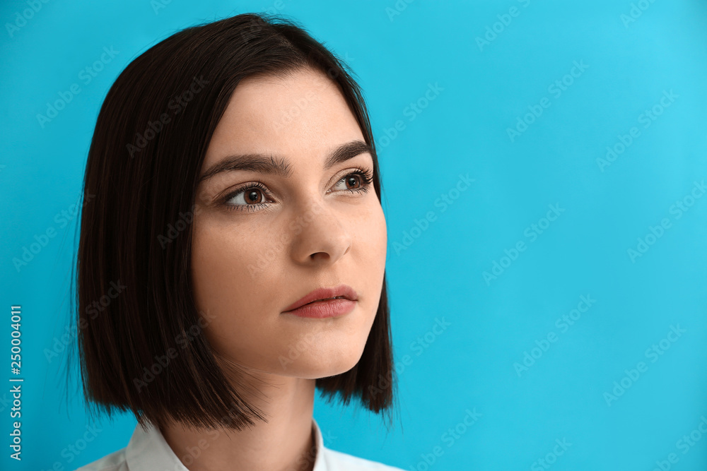 Portrait of young woman on color background