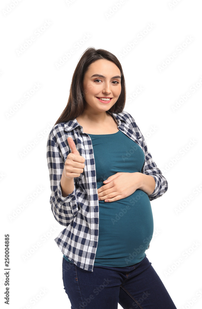 Beautiful pregnant woman showing thumb-up gesture on white background