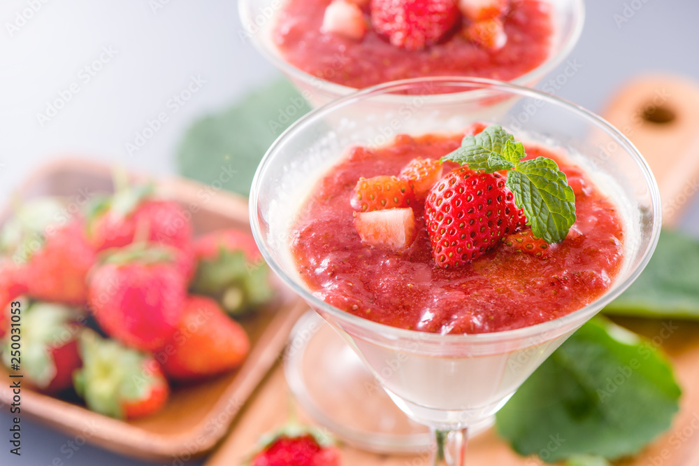 Delicous and nutritious double color (colour) strawberry desserts with mint and diced sarcocarp topp