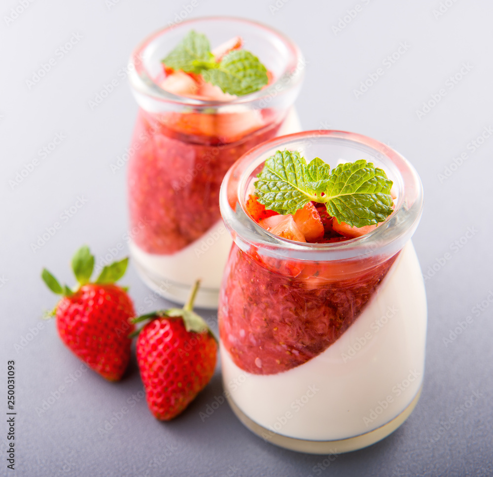 Delicous and nutritious double color (colour) strawberry desserts with mint and diced sarcocarp topp