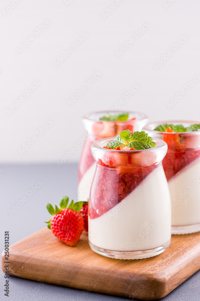 Delicous and nutritious double color (colour) strawberry desserts with mint and diced sarcocarp topp