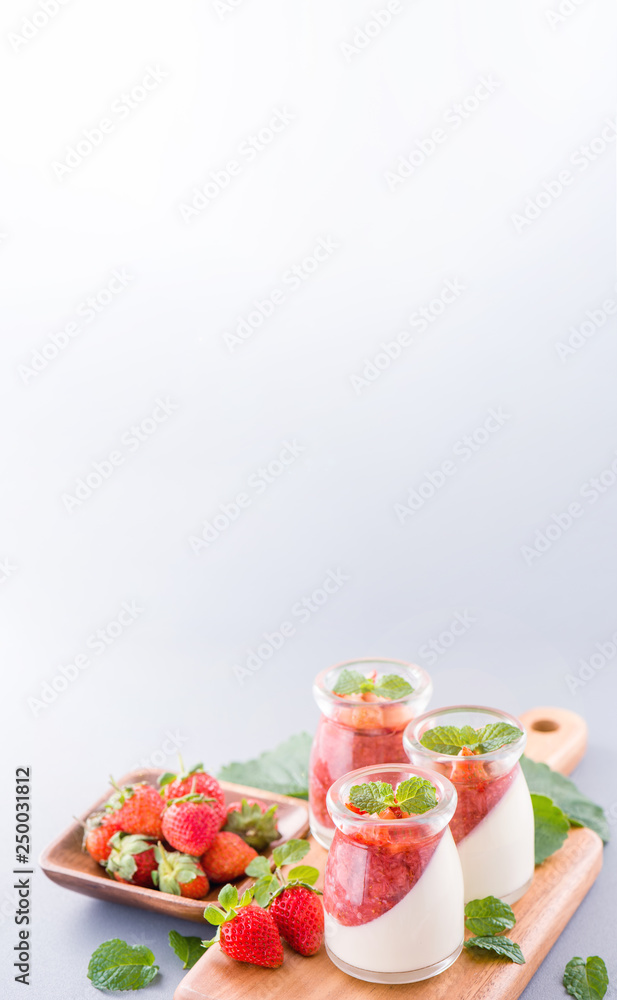 Delicous and nutritious double color (colour) strawberry desserts with mint and diced sarcocarp topp