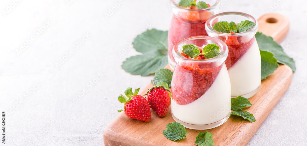 Delicous and nutritious double color (colour) strawberry desserts with mint and diced sarcocarp topp