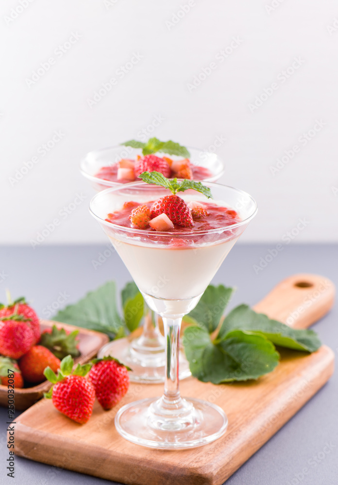 Delicous and nutritious double color (colour) strawberry desserts with mint and diced sarcocarp topp