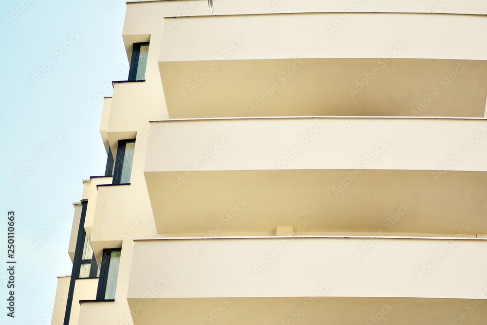 Modern white building with balcony on a blue sky