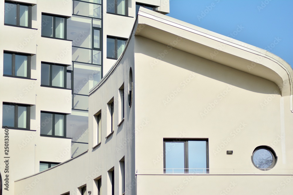 Modern white building with balcony on a blue sky