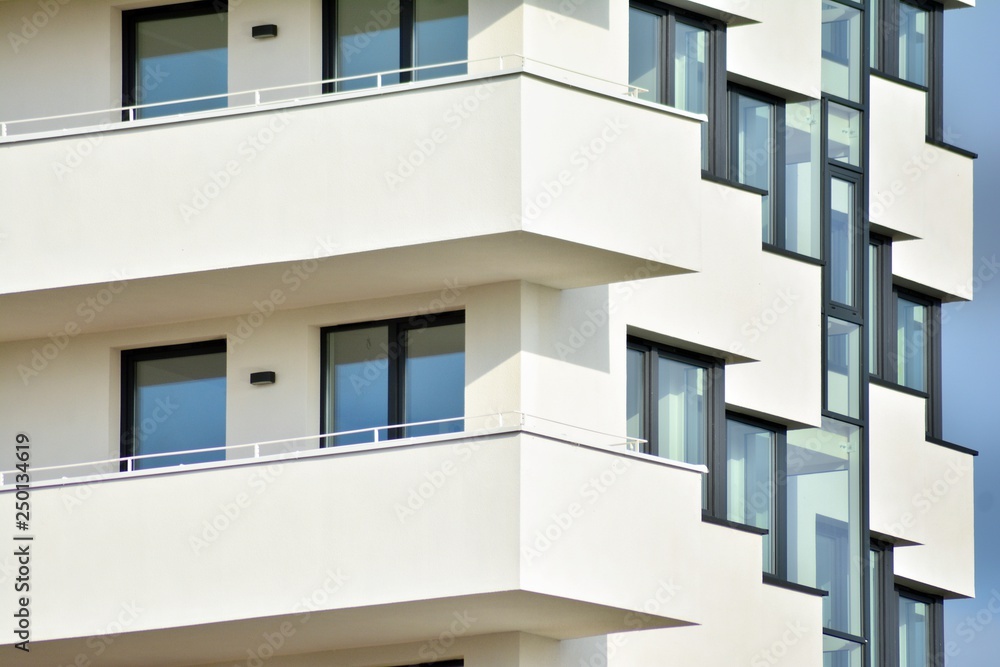 Modern white building with balcony on a blue sky