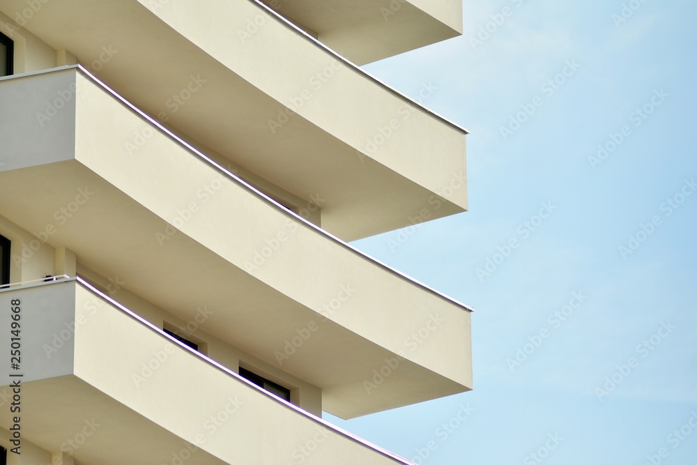 Modern white building with balcony on a blue sky