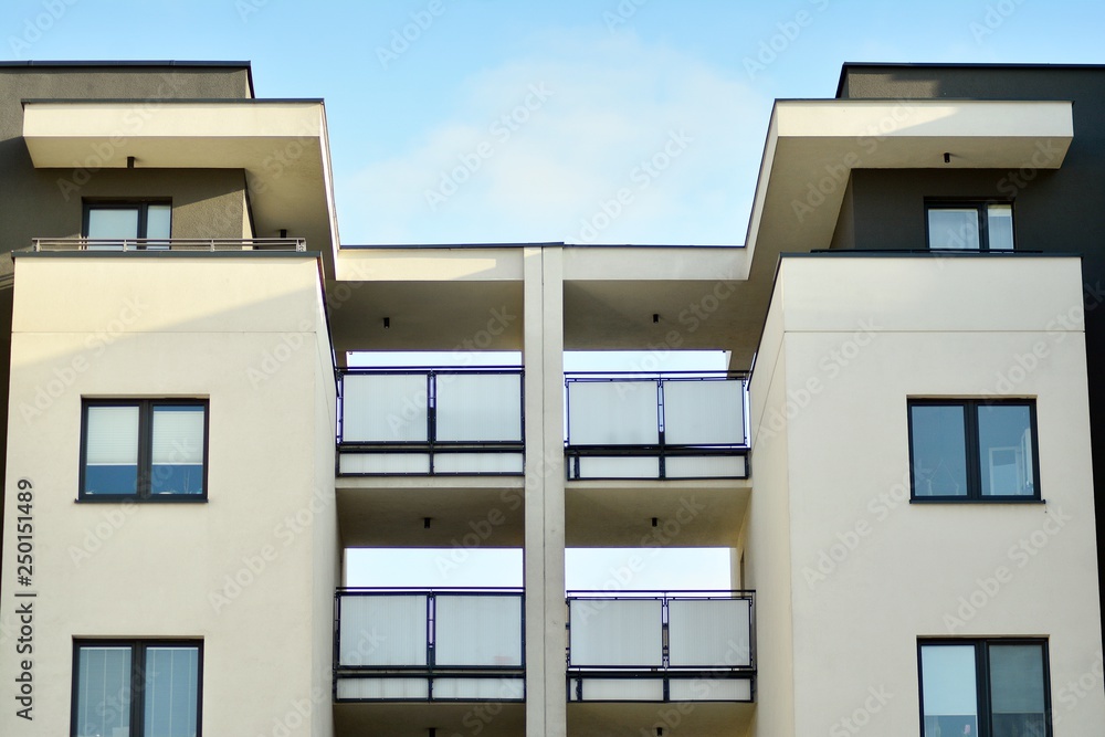 Modern white building with balcony on a blue sky