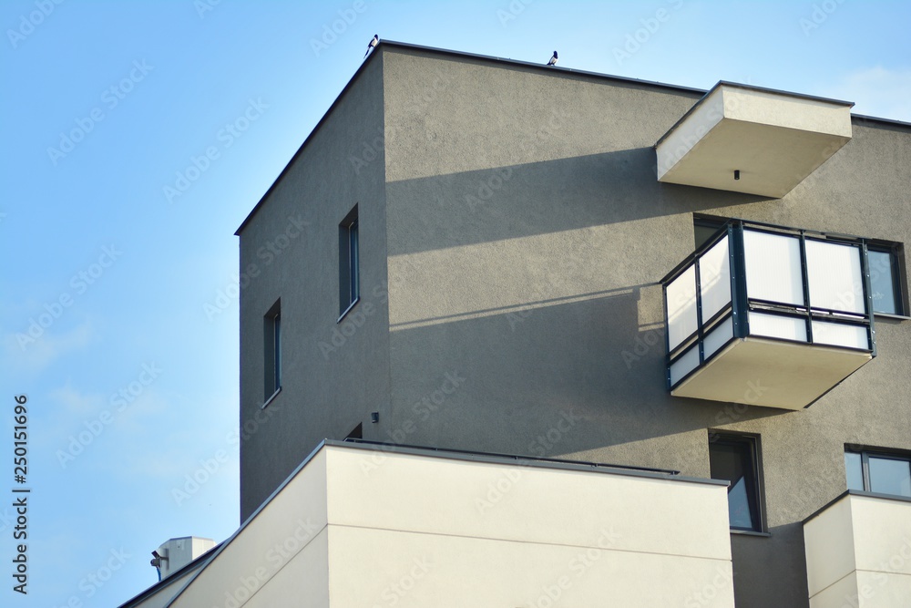 Modern white building with balcony on a blue sky