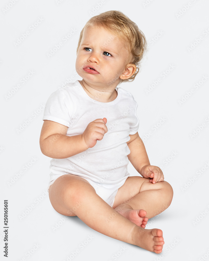 Baby sitting on the floor in a studio