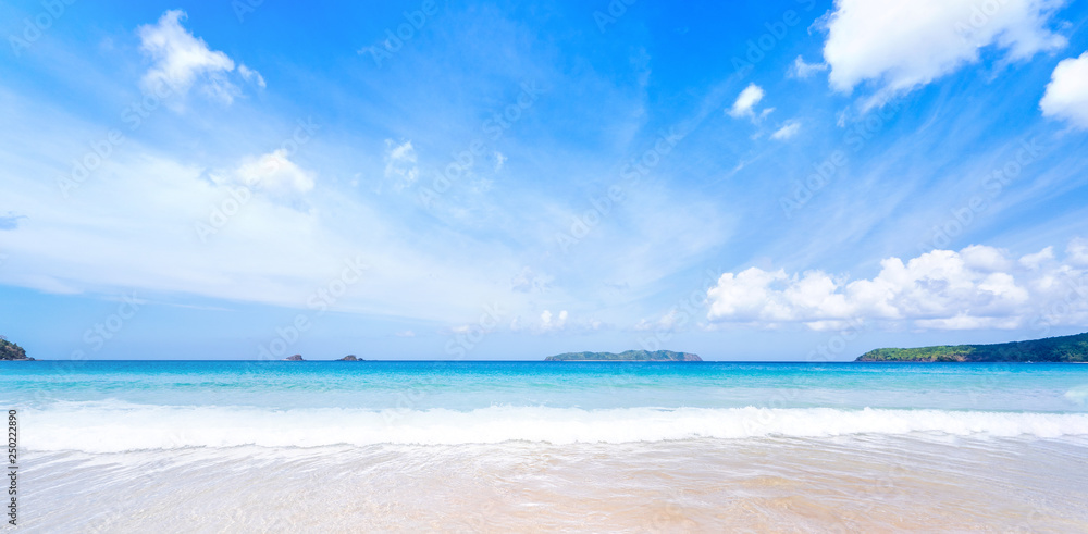 Beautiful amazing gold colored sandy beach with soft waves isolated with sunny blue sky. Concept of 