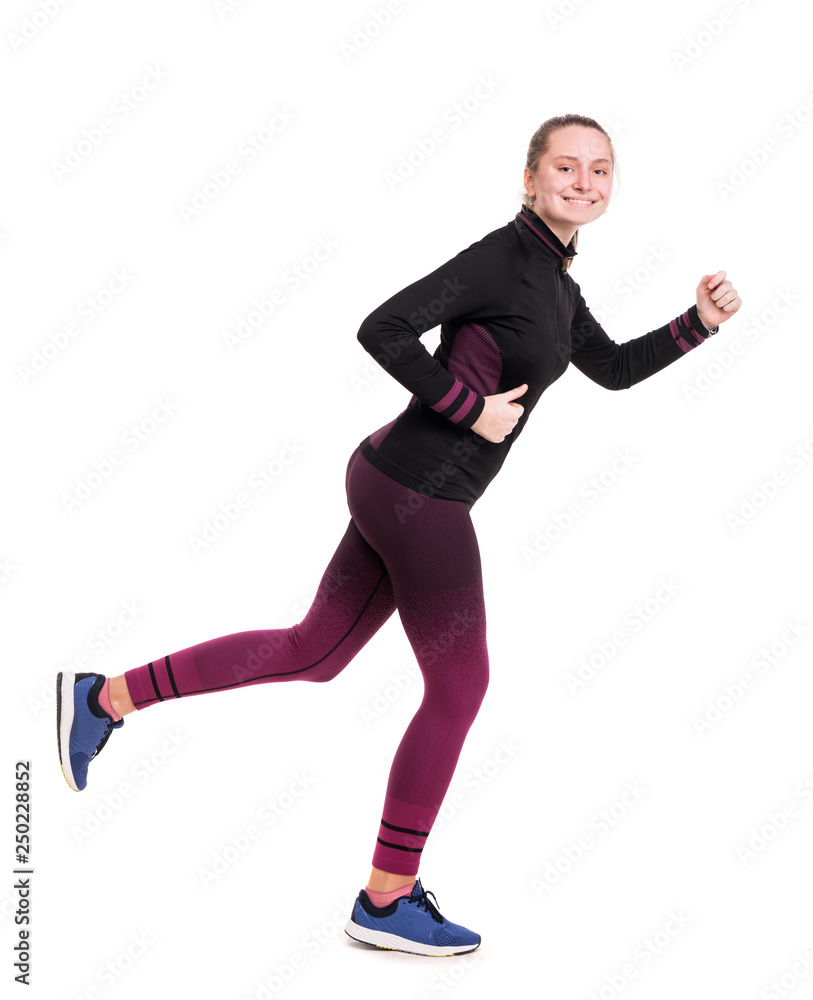 Smiling teen girl in sportswear working out in studio on a white background