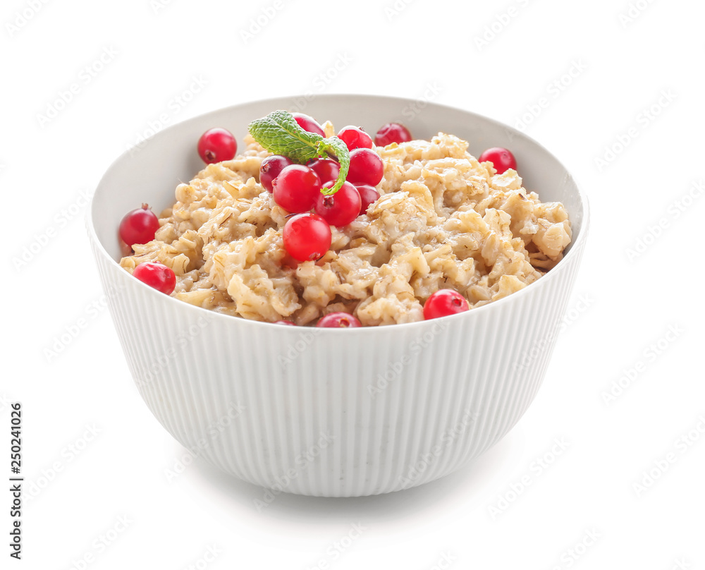 Bowl with tasty oatmeal on white background