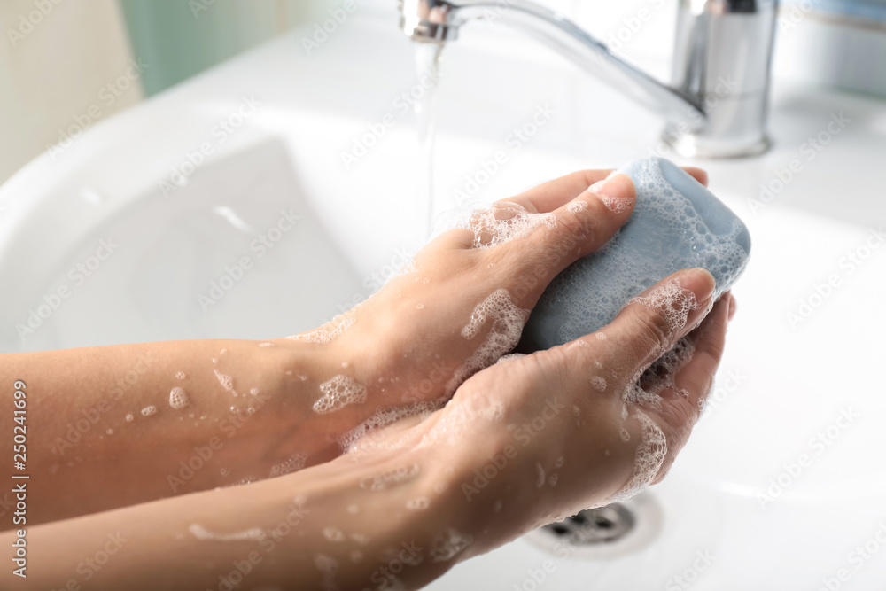 Woman washing hands in sink