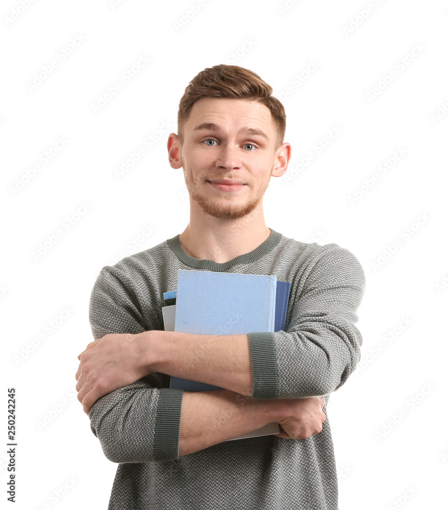 Handsome young man with books on white background