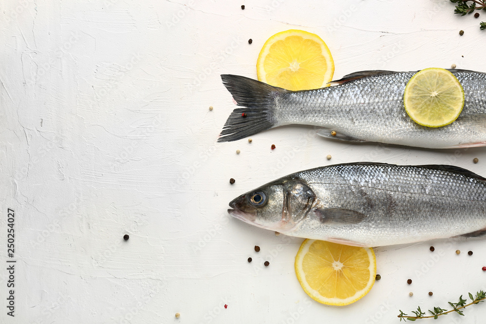 Tasty fresh seabass fish with spices on white background