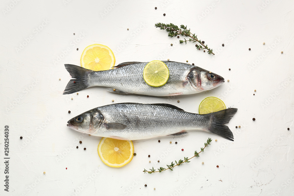 Tasty fresh seabass fish with spices on white background