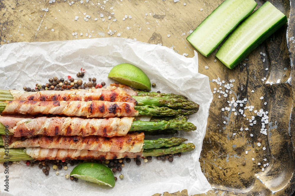 Tasty bacon wrapped asparagus on metal tray