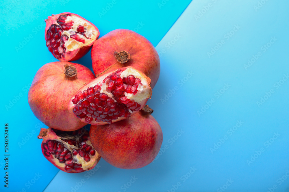 Ripe pomegranates on color background