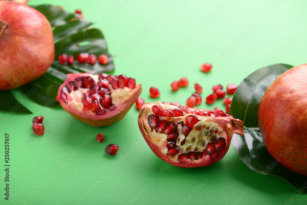 Ripe pomegranates on color background