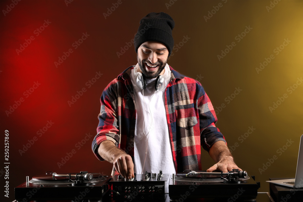 Male DJ playing music in club