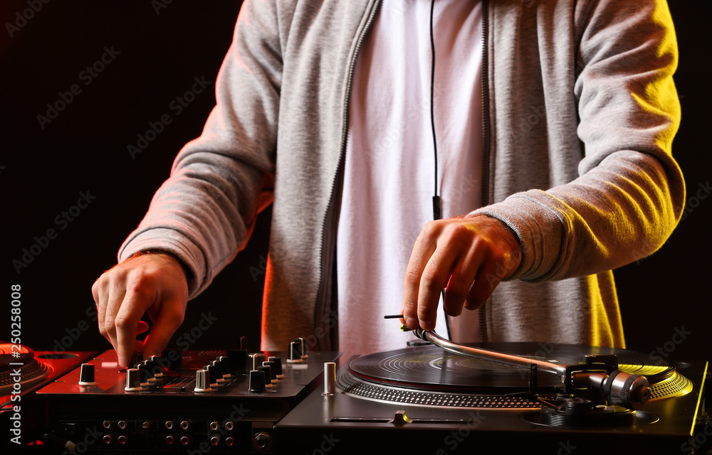 Male DJ playing music in club