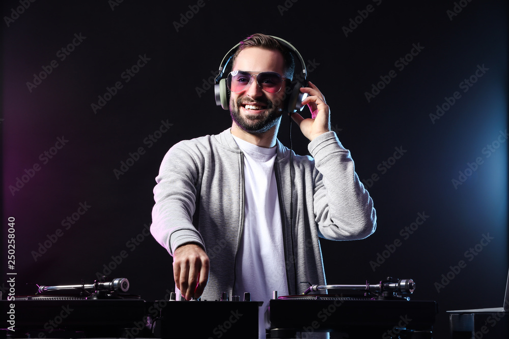 Male DJ playing music in club