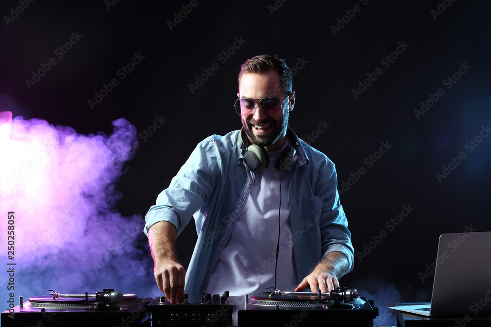 Male DJ playing music in club