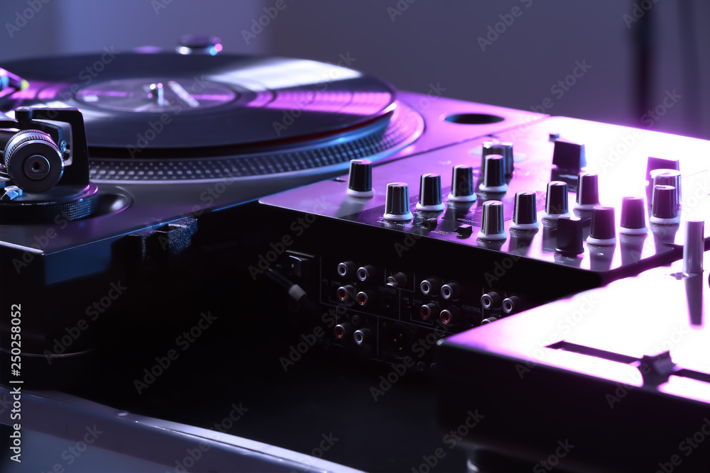 Modern DJ mixer in club, closeup