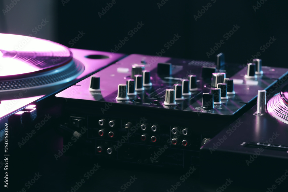 Modern DJ mixer in club, closeup