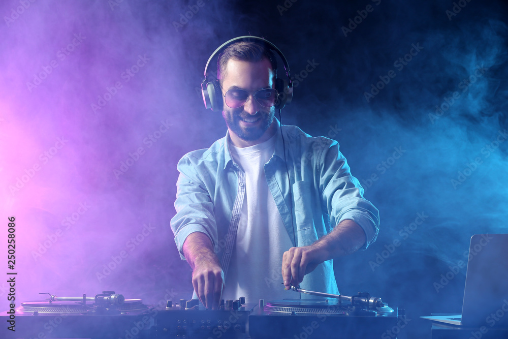 Male DJ playing music in club