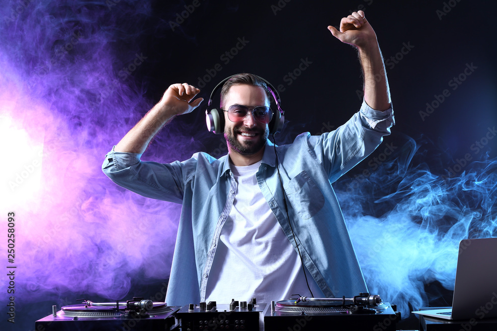 Male DJ playing music in club