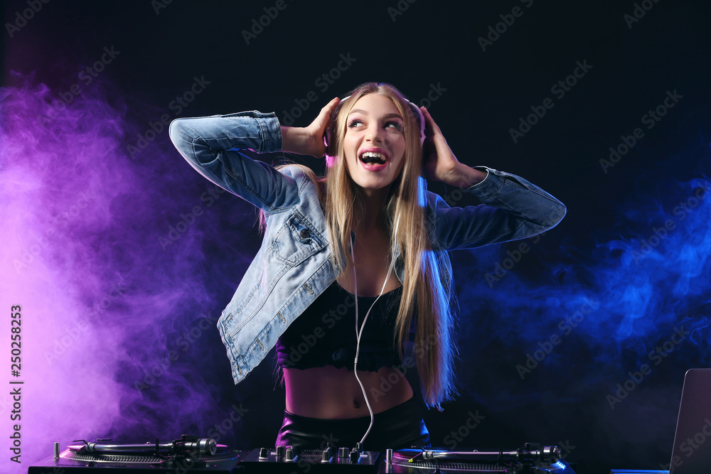 Female DJ playing music in club