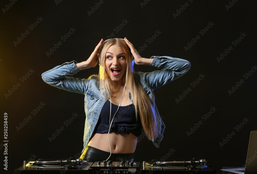 Female DJ playing music in club