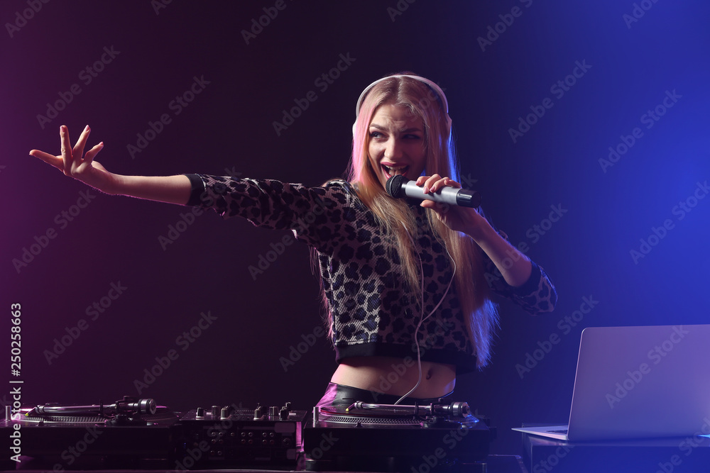 Female DJ playing music in club