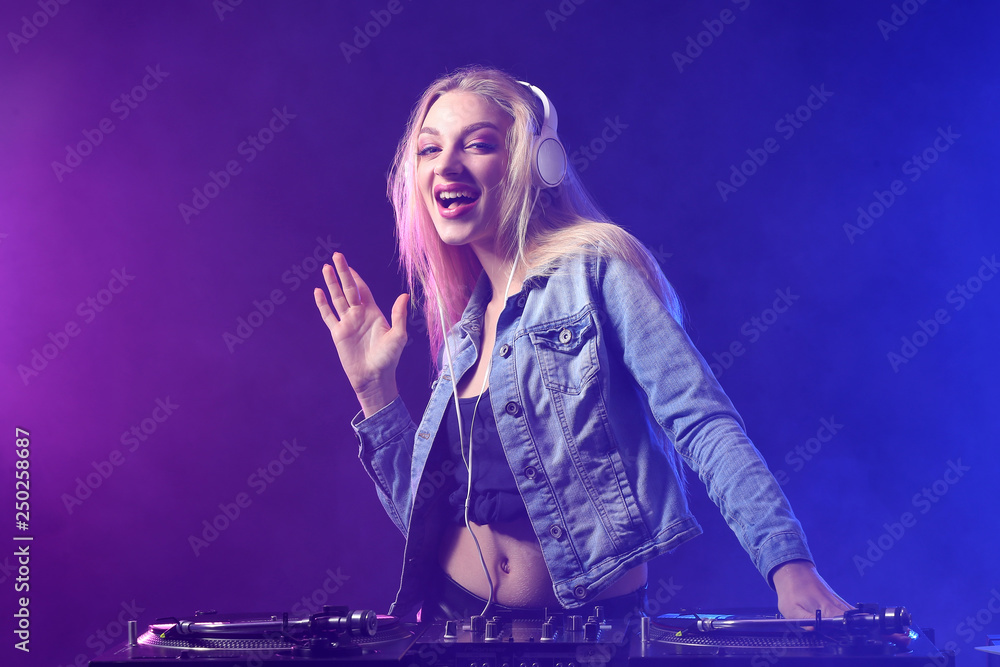 Female DJ playing music in club