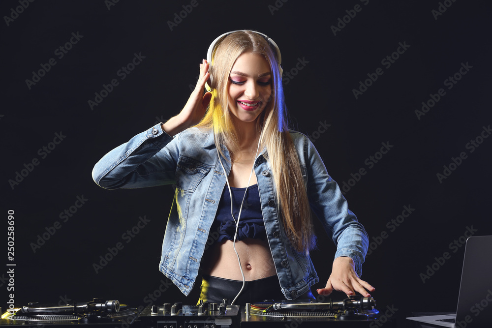 Female DJ playing music in club