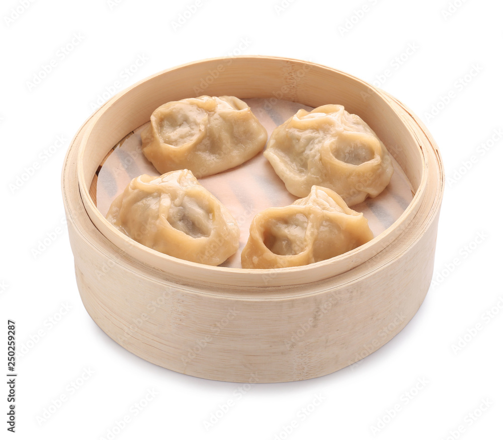 Bamboo steamer with tasty dumplings on white background