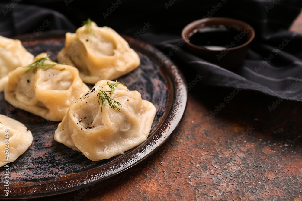 Plate with tasty dumplings on table