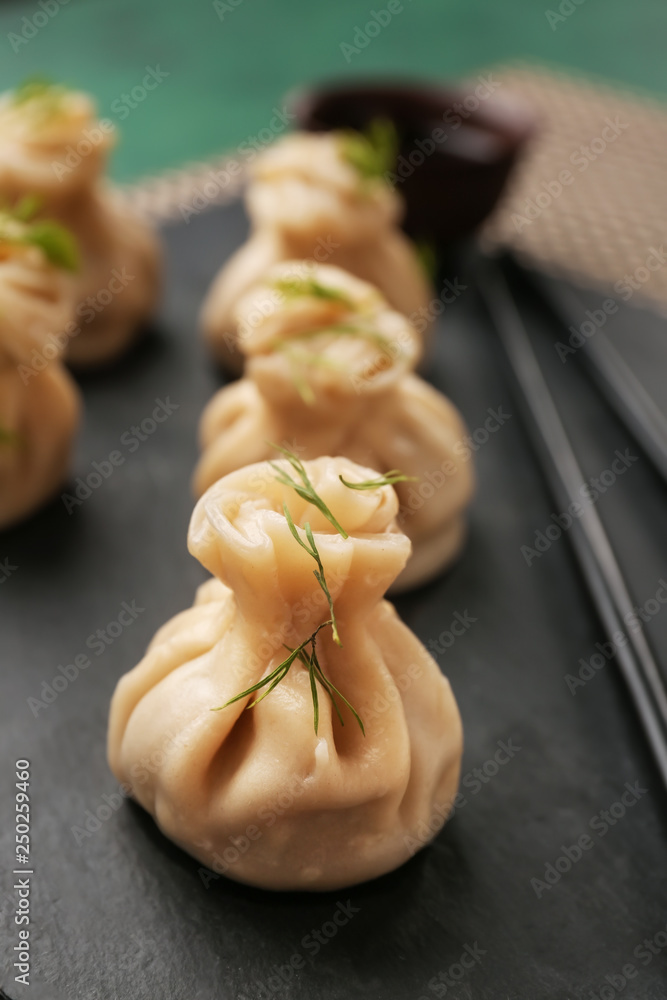 Tasty dumplings on slate plate, closeup