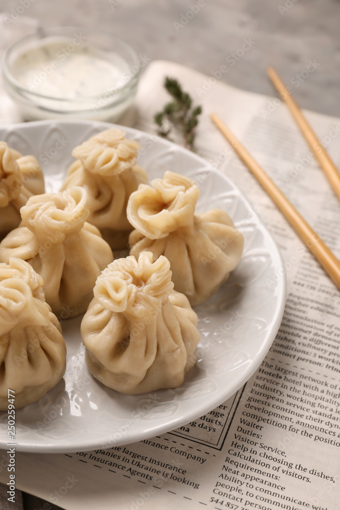 Plate with tasty dumplings on table