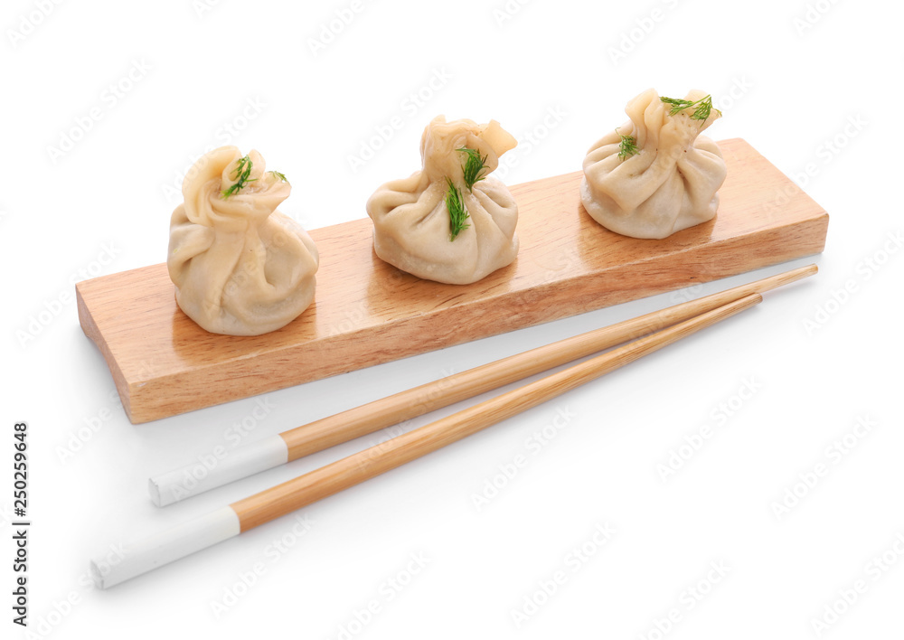 Board with tasty dumplings on white background