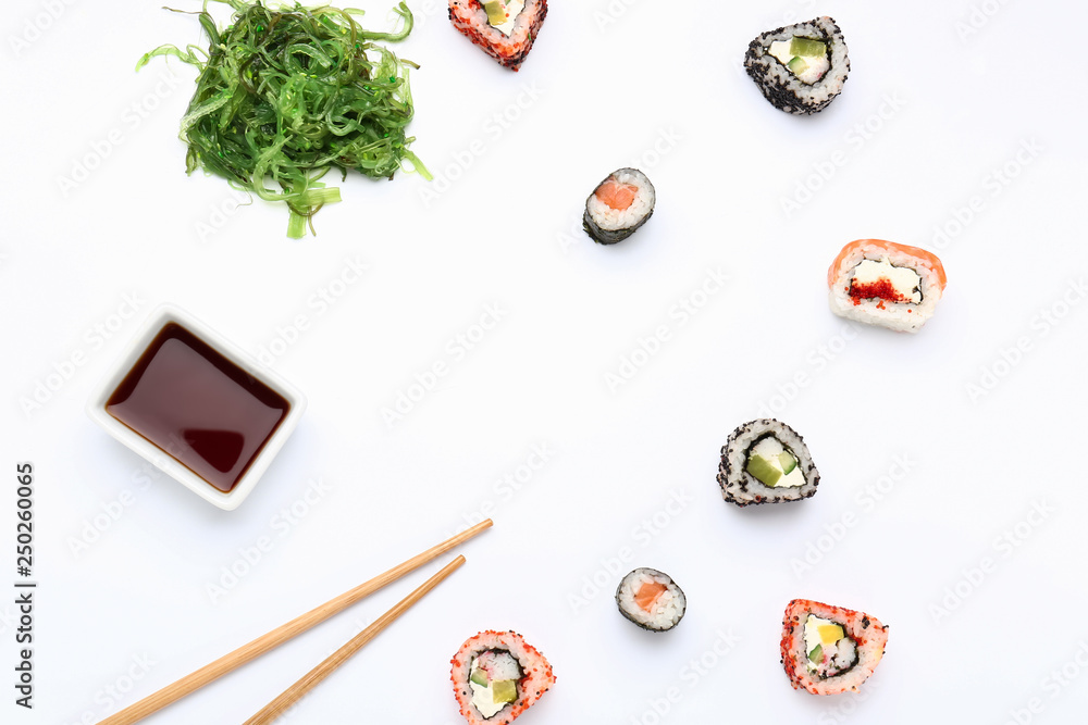 Composition with tasty sushi rolls on white background