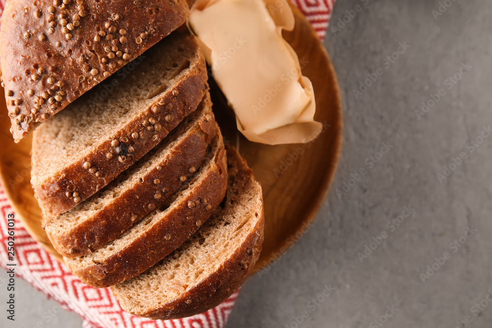 Plate with cut fresh bread on table