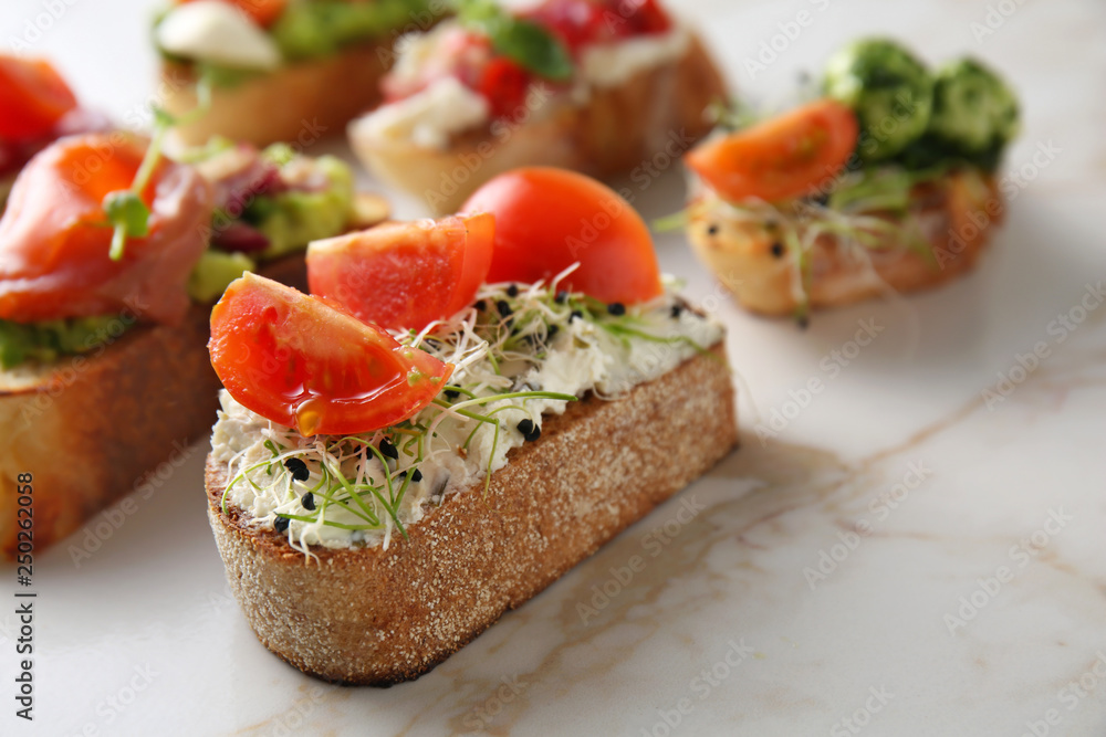 Fresh tasty bruschettas on light background