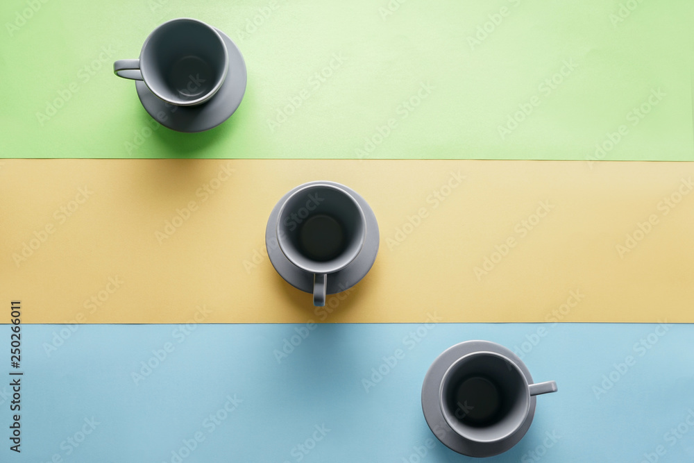 Empty cups on color background