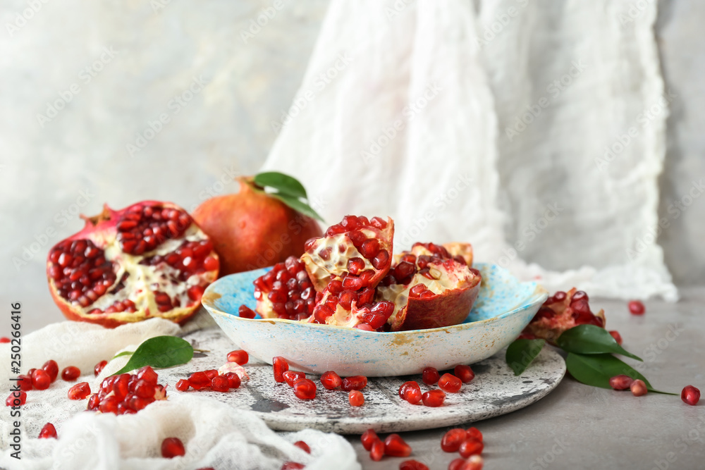 Composition with tasty pomegranates on table